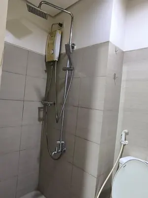 a shower in a bathroom with a toilet at Shore B 524 in Manila