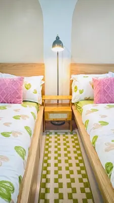 two beds sitting next to each other in a room at Japanese Inspired Hotel at MOA in Manila
