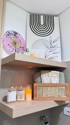 a shelf in a bathroom with towels and candles at Japanese Inspired Hotel at MOA in Manila