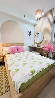 a bedroom with a large bed and a desk at Japanese Inspired Hotel at MOA in Manila