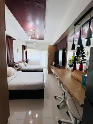 a hotel room with two beds and a desk at 2 Bed's Unit at PICC Near MOA in Manila