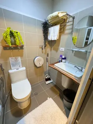 a bathroom with a toilet and a sink at 2 Bed's Unit at PICC Near MOA in Manila