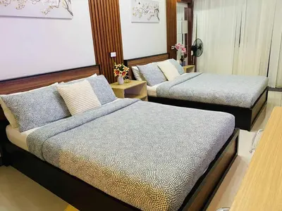a room with two beds in a room at 2 Bed's Unit at PICC Near MOA in Manila