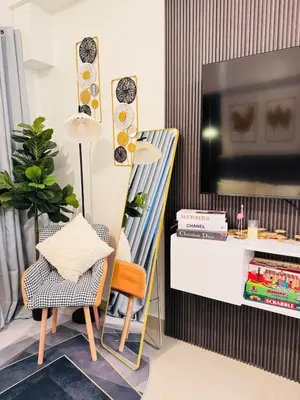 a living room with a tv and a chair at Hotel like Condo at Pasay in Manila