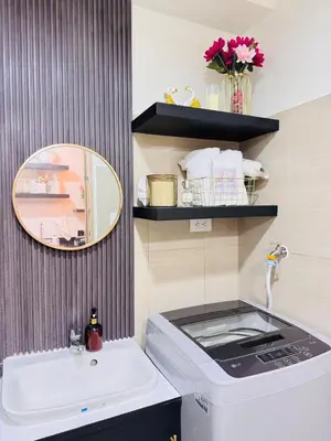 a bathroom with a washing machine and a sink at Hotel like Condo at Pasay in Manila