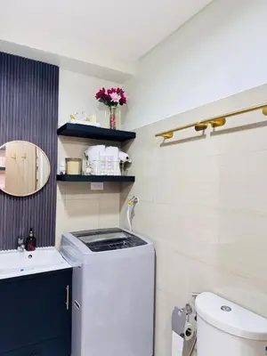 a small bathroom with a sink and a washing machine at Hotel like Condo at Pasay in Manila