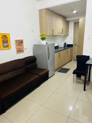 a living room with a couch and a kitchen at Apartment Rm# 839 B shore 1 in Manila