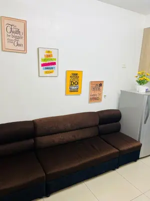 a brown couch in a room with signs on the wall at Apartment Rm# 839 B shore 1 in Manila