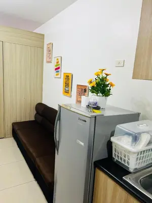 a kitchen with a refrigerator and a couch at Apartment Rm# 839 B shore 1 in Manila