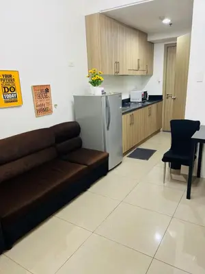 a living room with a couch and a kitchen at Apartment Rm# 839 B shore 1 in Manila