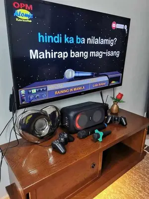a tv sitting on top of a wooden table at Shore 3 tower 2 mall of Asia staycation in Manila