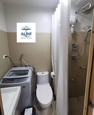 a small bathroom with a toilet and a shower at Shore 3 tower 2 mall of Asia staycation in Manila