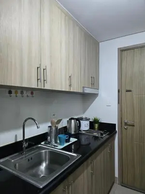 a kitchen with a sink and a counter top at Mall of Asia - SMDC Shore in Manila