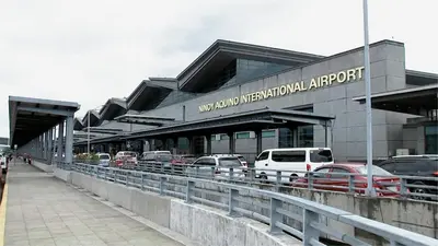 a parking lot with cars parked in front of an airport at Mall Of Asia - Shore2 Residences in Manila