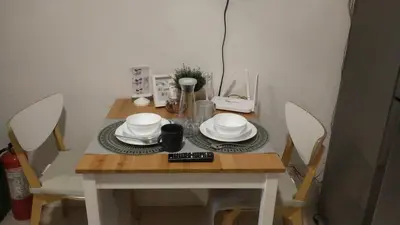 a small table with plates and bowls on it at SMDC Apartment in FAME in Manila
