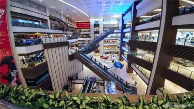 an overhead view of a shopping mall with escalators at SMDC Apartment in FAME in Manila