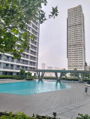 a swimming pool in a city with tall buildings at SMDC Fame Condo in Manila