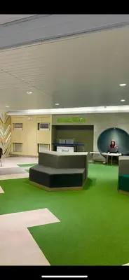 a lobby with green carpet and a table and chairs at Smdc green 2 residence in Pasong Bayog