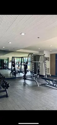 a gym with several tread machines in a room at Smdc green 2 residence in Pasong Bayog
