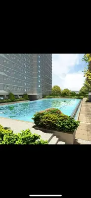 a large swimming pool in front of a building at Smdc green 2 residence in Pasong Bayog