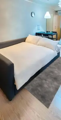 a large bed in a room with a table at Private Modern Condo in BGC in Manila
