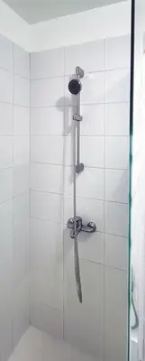 a shower with a shower head in a bathroom at Private Modern Condo in BGC in Manila