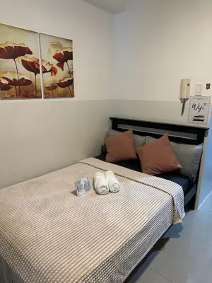 a bedroom with a bed with two towels on it at Shore Residence by CozyHaven's Homestay in Manila