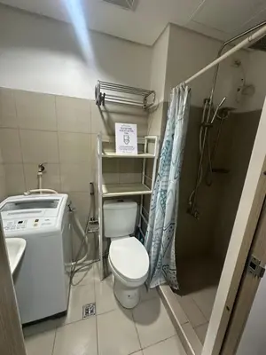 a small bathroom with a toilet and a sink at Shore Residence by CozyHaven's Homestay in Manila
