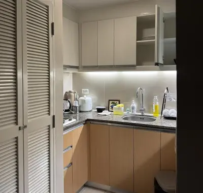 a kitchen with a sink and a counter top at Elegant 1BR with Great View, Panoramic Pool Near Ortigas CBD - 24 in Manila