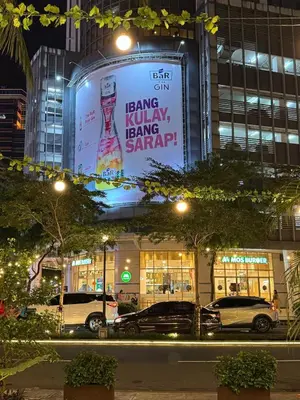 a sign on the side of a building at night at Elegant 1BR with Great View, Panoramic Pool Near Ortigas CBD - 24 in Manila