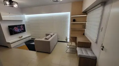 a living room with a couch and a chair at The Atherton- Spacious Modern Condo Unit in Paranaque Near the Airport, Makati, BGC and Highways in Manila