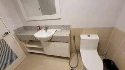 a bathroom with a toilet and a sink at The Atherton- Spacious Modern Condo Unit in Paranaque Near the Airport, Makati, BGC and Highways in Manila