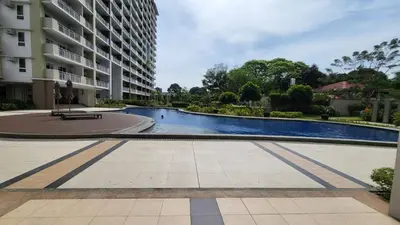 a swimming pool in the middle of a building at The Atherton- Spacious Modern Condo Unit in Paranaque Near the Airport, Makati, BGC and Highways in Manila