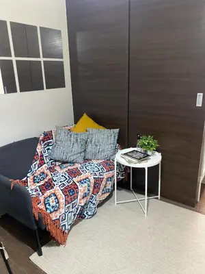 a room with a bed and a table with a table at Casa Beatrice Staycation in Manila