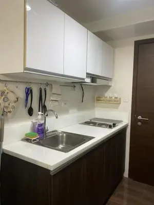 a kitchen with a sink and a counter top at Casa Beatrice Staycation in Manila