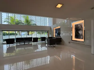 a dining room with tables and chairs in a building at Jazz Residences Makati in Manila