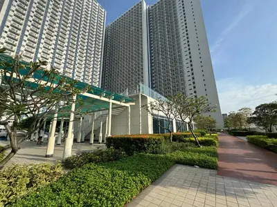 a building with two tall skyscrapers in a city at Jazz Residences Makati in Manila