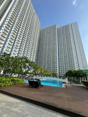 two large buildings with a pool in front of them at Jazz Residences Makati in Manila
