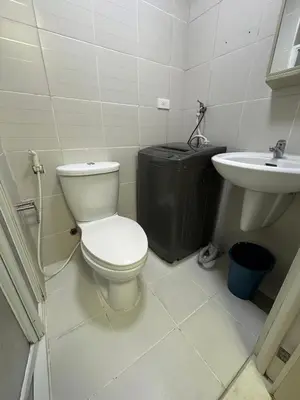 a bathroom with a toilet and a sink at Jazz Residences Makati in Manila