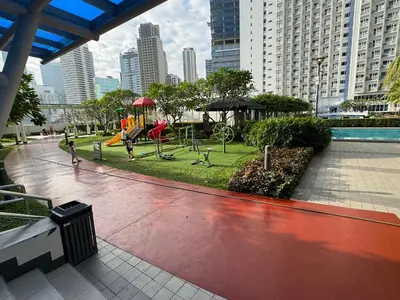 a park with a playground in a city at Jazz Residences Makati in Manila