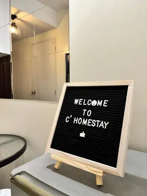 a sign that says welcome to a homaway at C homestay fullerton suites in Silang