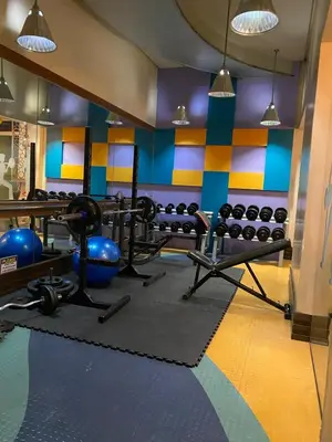 a gym with lots of equipment in a room at Forbeswood Garden Suite Parklane BGC in Manila