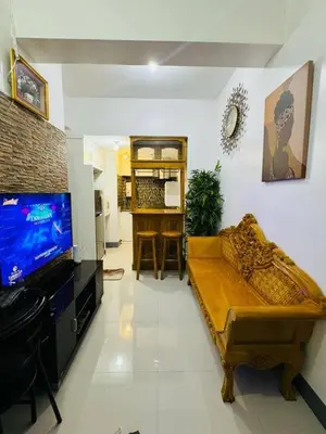 a living room with a couch and a flat screen tv at Casa Lily in Manila