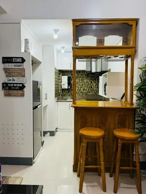 a kitchen with a counter and two stools at Casa Lily in Manila