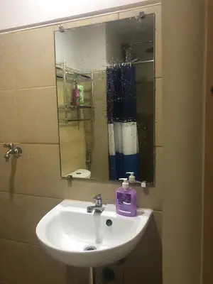 a bathroom with a sink and a mirror at Field Residence Staycation in Manila