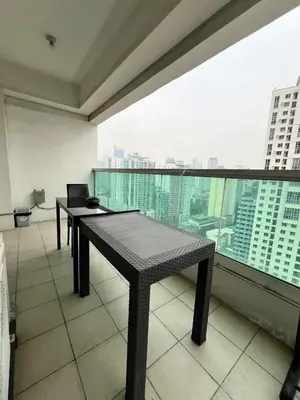 a balcony with two tables and a view of a city at Tower 1 Rm 305 FREE Parking, FREE Pool, Balcony, 1Bedroom 4 beds in Manila