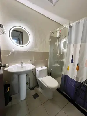 a bathroom with a toilet and a sink and a shower at Tower 1 Rm 305 FREE Parking, FREE Pool, Balcony, 1Bedroom 4 beds in Manila