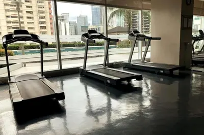 a gym with three treadmills in a building at Tower 1 Rm 305 FREE Parking, FREE Pool, Balcony, 1Bedroom 4 beds in Manila