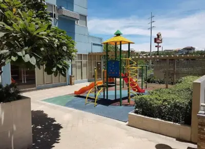 a playground with a slide in a building at M&M Suites Ridgewood Towers T3 BGC McKinley in Manila