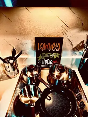 a stove top with three pots on top of it at Luxurious 2 Bedroom Oasis in Air Residences with Bar KTV and Games in Manila